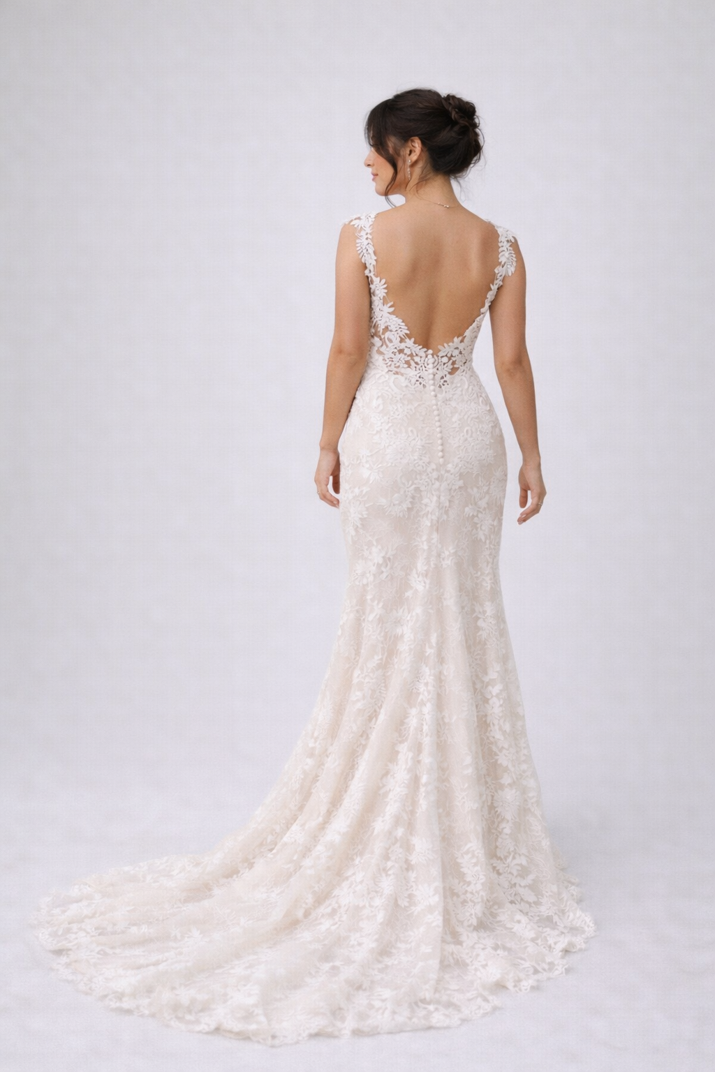 Back of a lace dress worn by a brunette woman